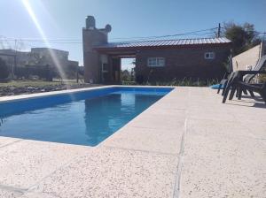 a swimming pool in front of a house at Los Fresnos Casa Quinta in La Picada +15 photos