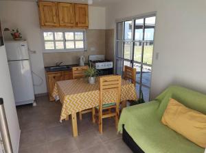a kitchen with a table and a couch in a room at Los Fresnos Casa Quinta in La Picada
