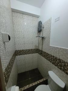 a bathroom with a toilet and a phone at 3era Habitación Privada a 1 cuadra de la plaza de armas in Oxapampa +5 photos