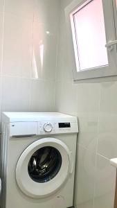 a washing machine in a small room with a window at Apartamento Leyda en Marbella in Marbella +26 photos