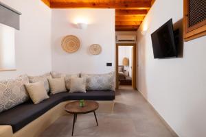 a living room with a couch and a table at Tapanis luxury house in Líndos