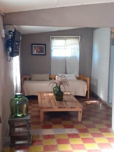 a living room with a bed and a table with a coffee table at LA ROTONDA in San Nicolás de los Arroyos +33 photos