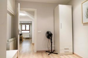 a room with a large white closet and a tripod at ENCANTO CUENCA Balcones De La Historia in Cuenca