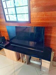 a large flat screen tv sitting on top of a cabinet at Kreyolita in Saint-Laurent du Maroni +8 photos