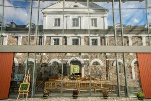 a reflection of a building in a window at Paliesiaus Dvaras in Mielagėnai
