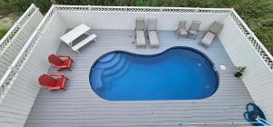 an overhead view of a swimming pool with chairs at 8528 Beach Road in Nags Head