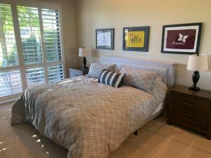 a bedroom with a bed with two pillows on it at Relax in Palm Valley Comfort in Palm Desert +14 photos