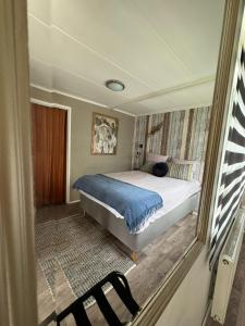 a bedroom with a bed and a chair in it at Elefteria in Kolhorn