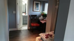 a hallway with a table in a room with a kitchen at Waterfront Home Windsor ,On, Ca in Windsor