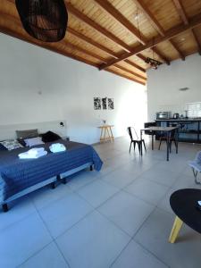 a bedroom with a bed and a table and chairs at TERRAZA TERRAZA Merlo Apartments in Merlo