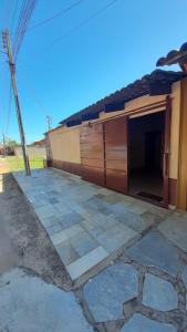 a building with a garage next to a house at Casa MTB in Pirenópolis