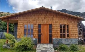 a log cabin with a large door at Puerto Río Tranquilo in Puerto Tranquilo