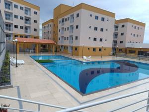 a large swimming pool in front of some buildings at Apartamento completo em Santarém in Santarém