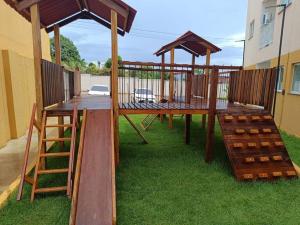a wooden deck with a table and a ladder at Apartamento completo em Santarém in Santarém