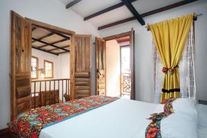 a bedroom with a bed and a window at El Encanto Mountain Cabin in Salento