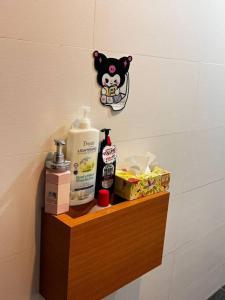 a shelf in a bathroom with toiletries on it at Kuromi卡通主题浪漫公寓 配有大屏幕蓝牙音响电影房 Netflix Youtube in Johor Bahru