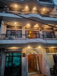 a building with a guest house with two balconies at Sunrise Guest House in Jaipur