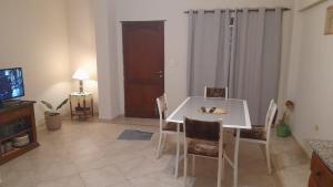 a dining room with a white table and chairs at La casa de los abuelos in Santiago del Estero