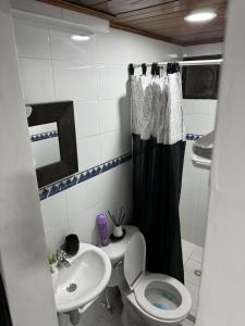 a small bathroom with a toilet and a sink at Casa central popa in Cartagena de Indias