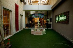 a building with a green floor with a fountain in it at Jordan View Hotel in Amman +63 photos