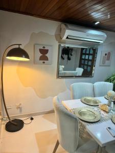 a dining room with a table and a lamp at Casa central popa in Cartagena de Indias