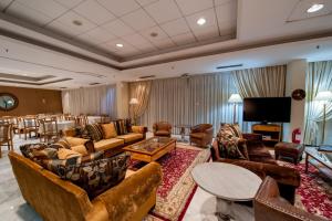 a large living room with couches and a table at Fthia Hotel in Lamía