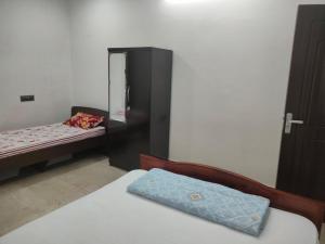 Postel nebo postele na pokoji v ubytování Mansons Homestay