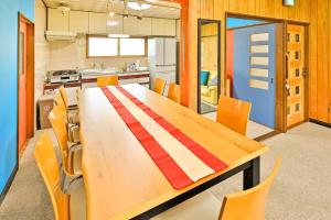 a kitchen with a long wooden table and chairs at Cottage Abashiri in Abashiri