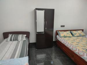 Postel nebo postele na pokoji v ubytování Mansons Homestay