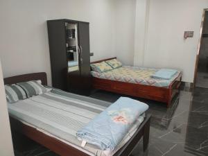 Postel nebo postele na pokoji v ubytování Mansons Homestay