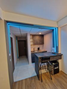 a kitchen with a counter and a table in a room at Vanilla Boutique Apartments in Skopje