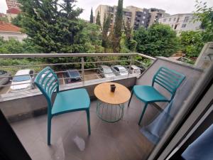 a table and chairs on a balcony with a view at Vanilla Boutique Apartments in Skopje