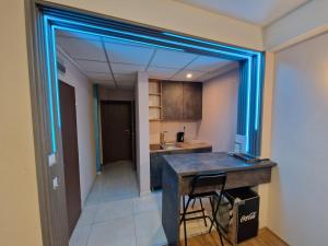 a kitchen with a counter with a blue glass window at Vanilla Boutique Hotel in Skopje