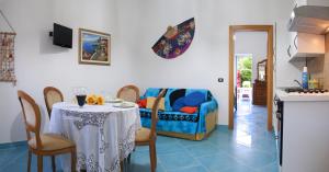 a living room with a table and a couch at Casa Vacanza Alice & Mari in Ascea