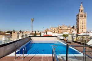 a swimming pool on the roof of a building at Hotel Casa 1800 Sevilla in Seville