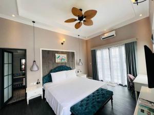 Giường trong phòng chung tại Vườn Vua Resort & Spa - Biệt Thự Khoáng Nóng 2 ngủ, ăn sáng và ăn tối