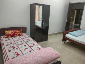 Postel nebo postele na pokoji v ubytování Mansons Homestay