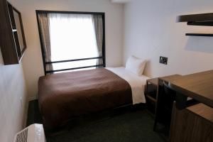 Postel nebo postele na pokoji v ubytování Belmont Hotel