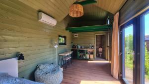 a room with a table and chairs in a house at Organicle Lodge in Sîncrăieni