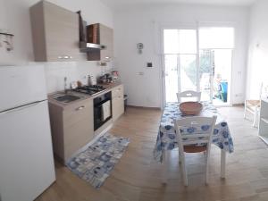 a kitchen with a table and a stove top oven at Casa Mare Ognina in Ognina +25 photos