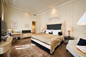 a hotel room with a bed and a desk at Wilson Palace by LOFT in Bratislava
