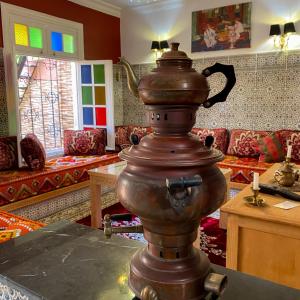 a room with a table with a kettles at Villa Dar Lghzal Private Villa with Garden, Rooftop & Authentic Dining in Rabat in Rabat