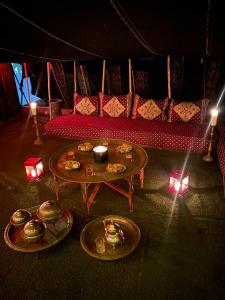a room with a table with plates of food and a couch at Villa Dar Lghzal Private Villa with Garden, Rooftop & Authentic Dining in Rabat in Rabat