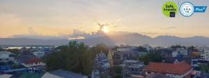 a view of a city with a sunset in the background at P Bliss hotel in Phayao