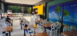 a restaurant with wooden tables and white chairs at SKYBLUE İSTANBUL HOTEL in Istanbul