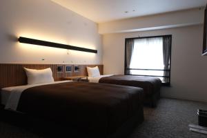 Postel nebo postele na pokoji v ubytování Belmont Hotel