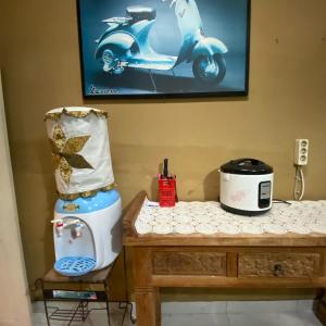 a table with a blender and a scooter on it at Kedyla Homestay Syariah in Ngabean
