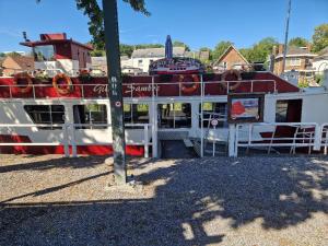 a boat that is sitting on the water at Gîte Le Sambre in Thuin