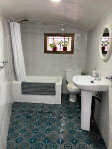 a bathroom with a tub and a toilet and a sink at Loft Rural Barcelona in Barcelona