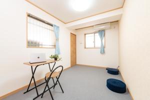 an empty room with a desk and a laptop at CASA Kobe 1st floor in Kobe